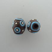 turquoise circles on dark oval bead