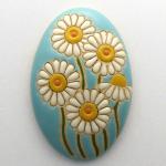 oval domed cabochon, daisees on light blue
