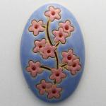 domed oval cabochon with blooming tree