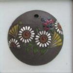 round pendant, flowers on dark backgroun