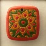 square pendant in green, orange and red