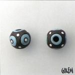 Turquoise blue circles on dark clay