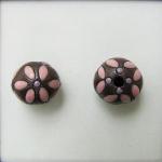 Pink leaves on dark round bead