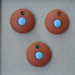 Turquoise circles on terracotta clay