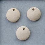 Unglazed pair of charms, off-white clay